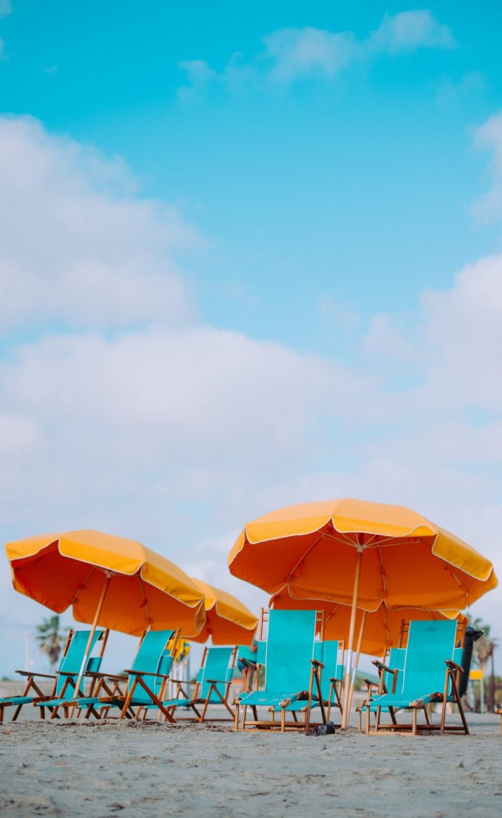 Closeup photo of lounger chairs and beach umbrellas